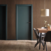 Energy-efficient custom door with decorative sidelights installed in suburban home.